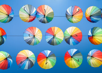 Fototapeta na wymiar Lots of colorful umbrellas in the sky. Colorful umbrellas background. 