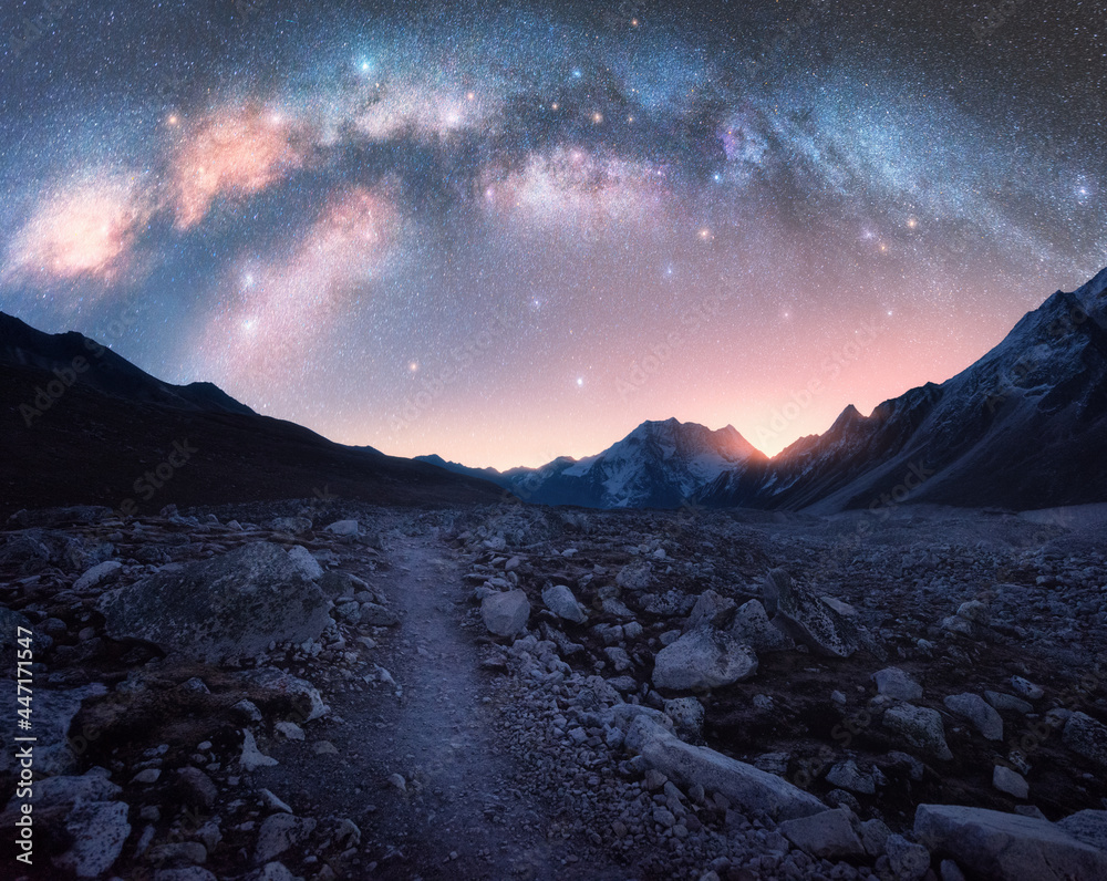 Wall mural arched milky way and mountains at night. beautiful landscape with bright milky way arch, rocky path,
