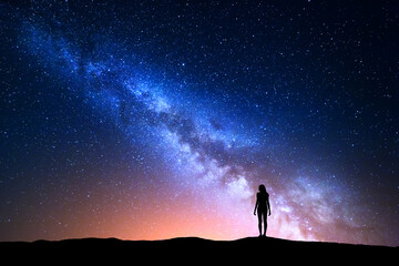 Beautiful Milky Way with standing woman. Colorful landscape with night sky with stars and...