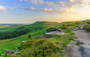Fototapeta na wymiar A Beautiful View of Stanage Edge On a Hilltop During Summer Sunset Near Peak District, England