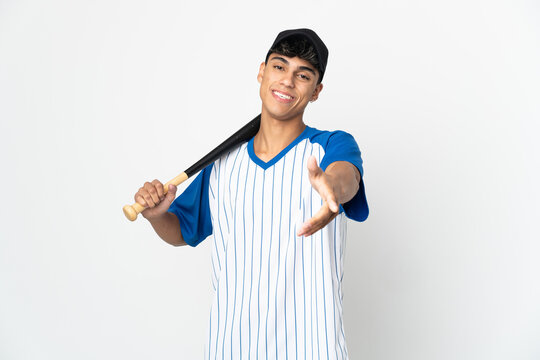 Man playing baseball over isolated white background shaking hands for closing a good deal