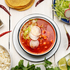 Mexican food. Red pozole with chicken on white background