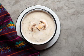Cream of mushroom soup on grey background. Vegetarian food