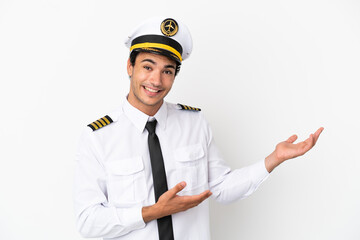 Airplane pilot over isolated white background extending hands to the side for inviting to come