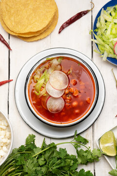 Mexican food. Red pozole with chicken on white background