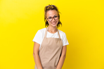 Restaurant waiter Russian girl isolated on yellow background laughing