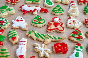 Homemade Christmas cookies with icing. Sloppy painted gingerbread cookies. Kids decoration project. 