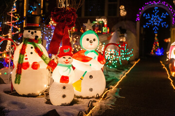 Christmas decorations. Family of glowing snowmen. Copy space