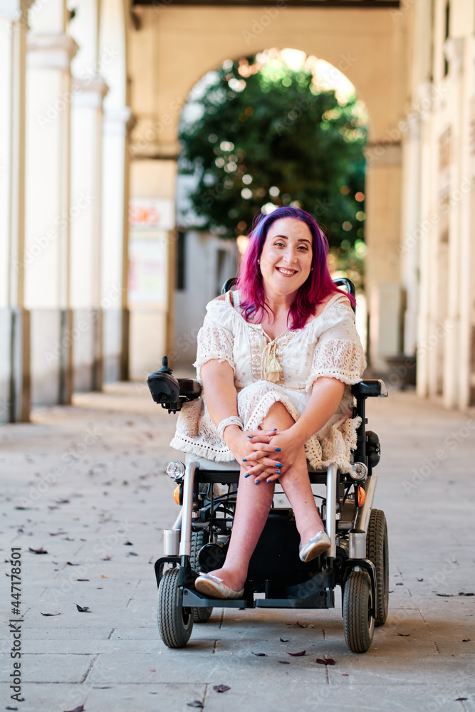 Wall mural a happy woman in a wheelchair looking at camera