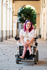 a happy woman in a wheelchair looking at camera