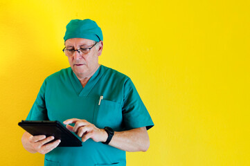 Studio portrait of a smiling doctor with a tablet health worker