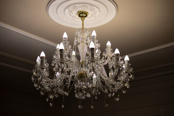 Glass chandelier. Ceiling light source.