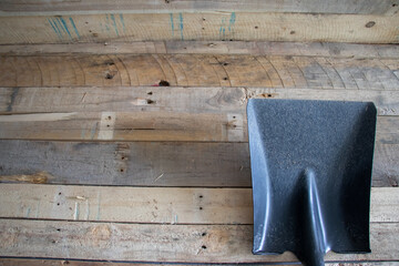 Fototapeta na wymiar Garden tootls, rake and shovel, spade shovel and square shovel. All on a wooden background.