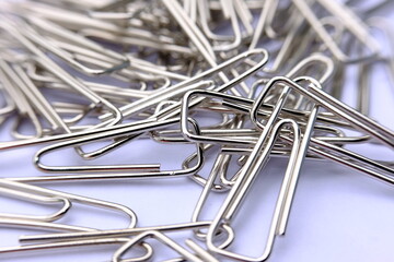 Close up paper clip on white background, and macro paper clip,  office equipment