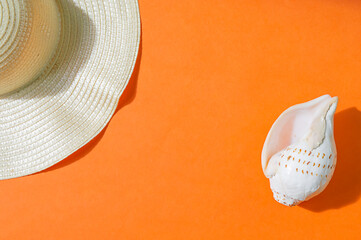 Fototapeta premium Beach accessories on orange background, copy space.