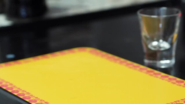 Female Hand Takes A Shot Glass Of B52 Cocktail Drink On The Bar Counter. closeup
