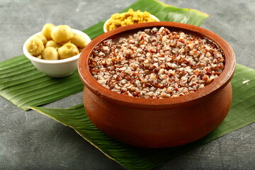 Brown rice porridge with husk, bran, cooked in clay pottery, Traditional Asian breakfast.