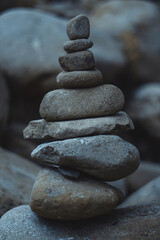 Fototapeta na wymiar Stack of stones. Mountain stones. Balancing stones. Figure of stones. Smooth gray stones. Zen stones