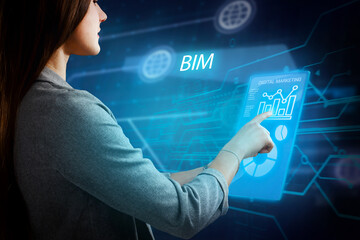 Business, Technology, Internet and network concept. Young businessman working on a virtual screen of the future and sees the inscription: BIM