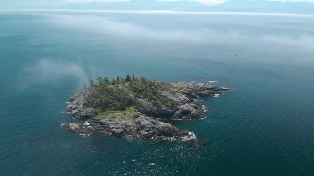 A aerial drone shot of the beautiful coastline with turquoise water near Sooke, BC. 4K 24FPS.
