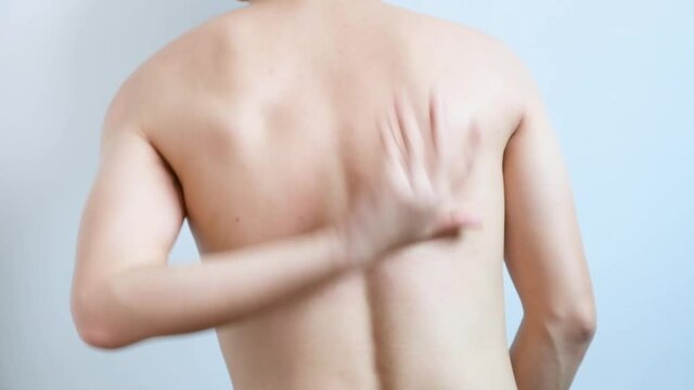 The man's hands he uses his hands to scratch his back because of dermatitis and itch sensation.