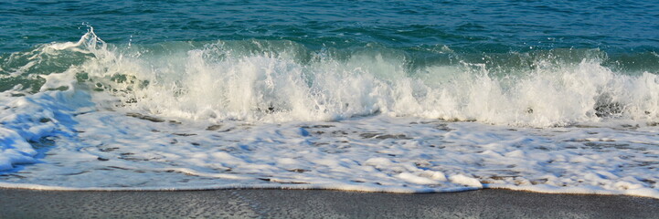 sea coast concept wide angle banner for design. sea sand and surf with white foam from wave with copy space