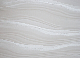 Fototapeta na wymiar White velvet, a fragment of fabric with a wavy pattern, close-up.