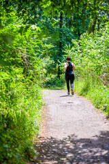 Fototapeta na wymiar Woman jogging on forest path for weight loss