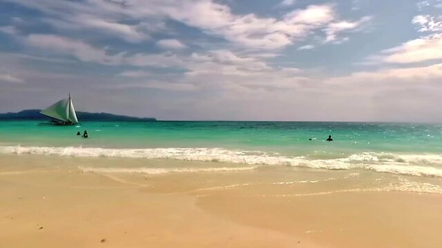 Typical morning at Boracay Beach, a popular tourist destination in the Philippines known for its lovely weather and long stretches of white sand.