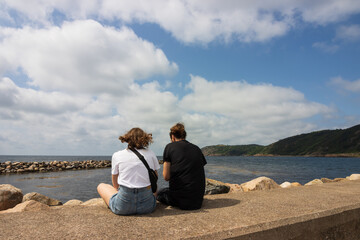 Fototapeta premium young couple sitting at the quay.