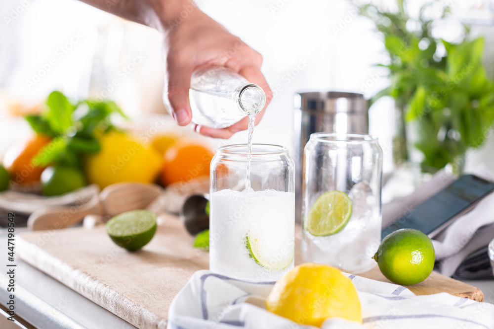 Wall mural mixologist making refreshing cocktail with hard seltzer at home