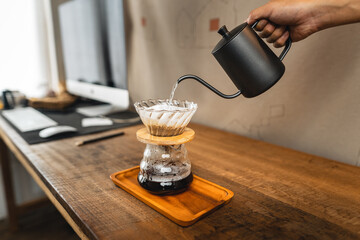 Pouring a hot water over a drip coffee