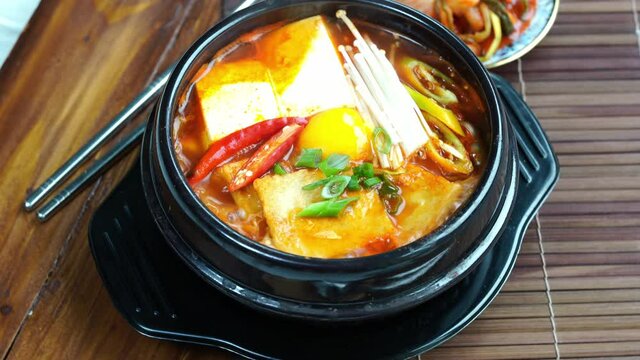 kimchi soup in hot iron pot, Korean traditional Kimchi soup with Tofu mushroom hot pot. 4k resolution