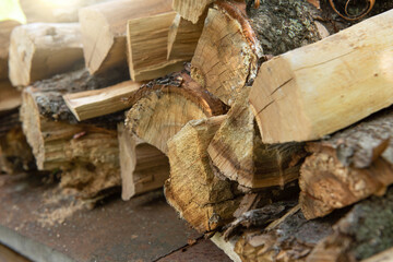Stacked firewood background. Firewood pattern. Wood saving wall. Stock of wood for kindling a fireplace for the winter. Natural materials background