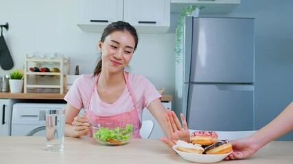 asian beautiful woman reject to eat donut and enjoying healthy foods.