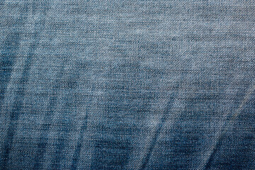 Denim jeans textile texture surface for background or wallpaper with copy space. Close up of blue jeans fabric pattern design.
