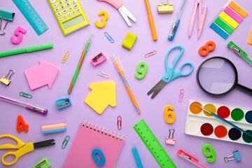 School supplies on purple background. Back to school concept.