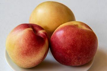 Nectarine Fruits on a plate isolated on white background.