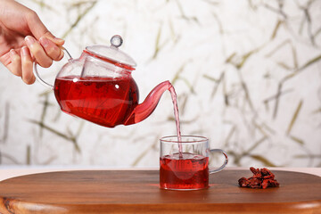 glass of glass of goji berry  tea and teapot
