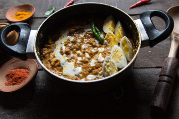 Chicken bharta prepared with shredded chicken, eggs, butter, cream along with Indian spices. A spicy rich gravy chicken dish. Close up.