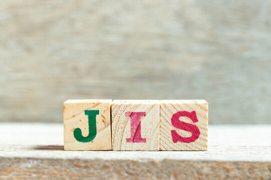 Alphabet letter block in word JIS (abbreviation of Just in sequence) on wood background