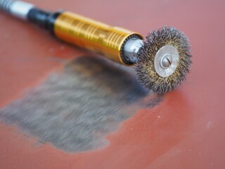 Rotary wire wheel brush. Cleaning of metal surfaces from rust and paint. Steel brush for drill