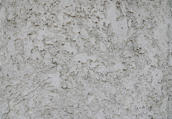 The background is made of rugged, gray-colored plaster walls.