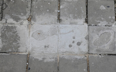 Footprints on the cement floor that have not yet dried on the pedestrian side of the road at Thailand.