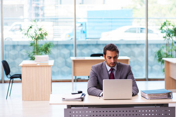 Young male employee working in the office