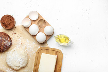 Fresh dough with ingredients for preparing bakery and utensils on light background