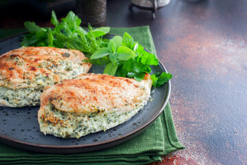 Baked chicken breast stuffed with cheese and spinach, horizontal, place for text or recipe