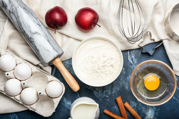 Ingredients for preparing bakery and utensils on color background