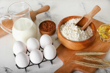 Ingredients for preparing bakery and utensils on light background