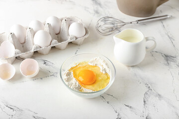 Ingredients for preparing bakery and utensils on light background
